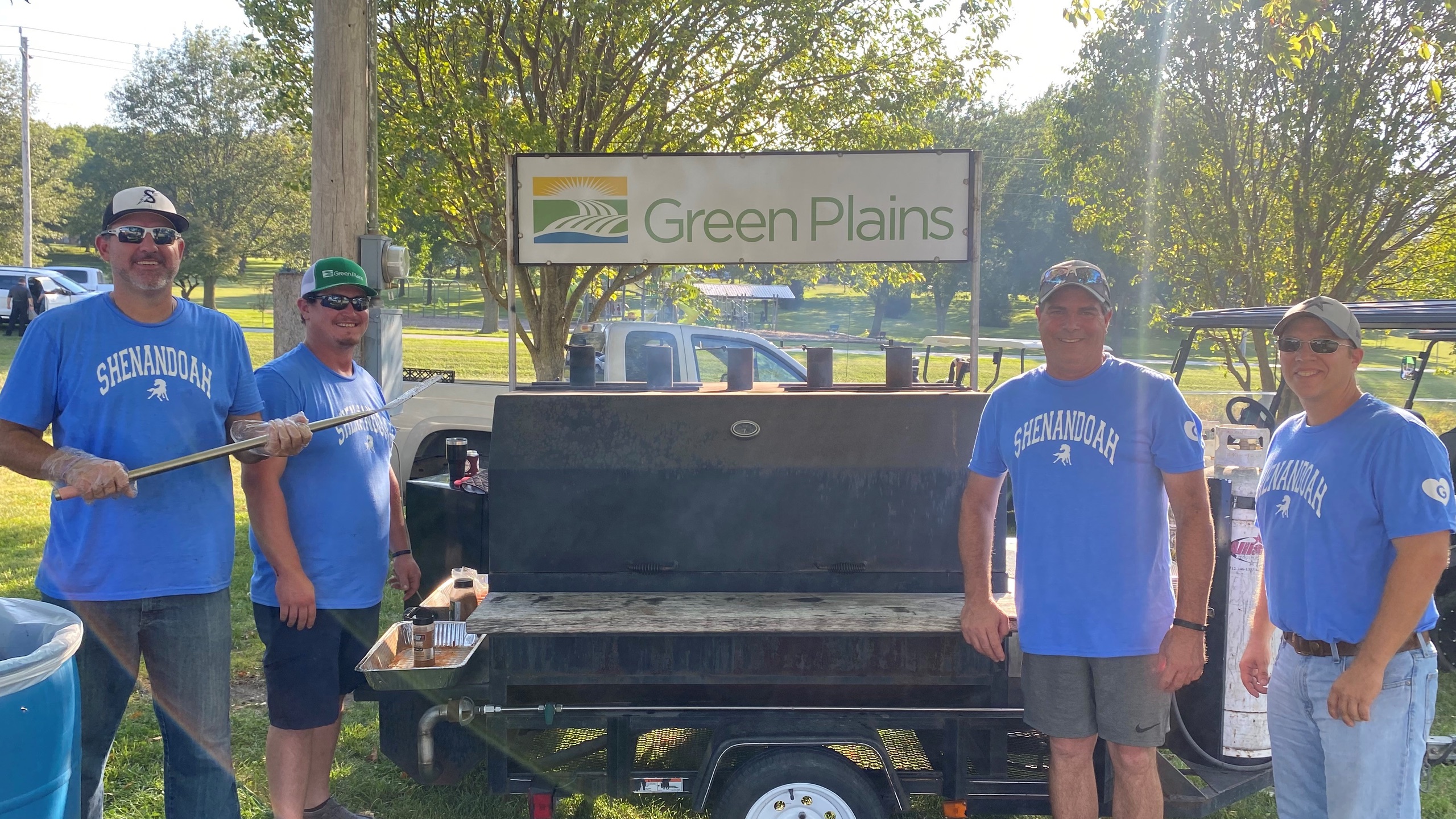 A Green Plains branded grill accompanied by the cookout grill masters