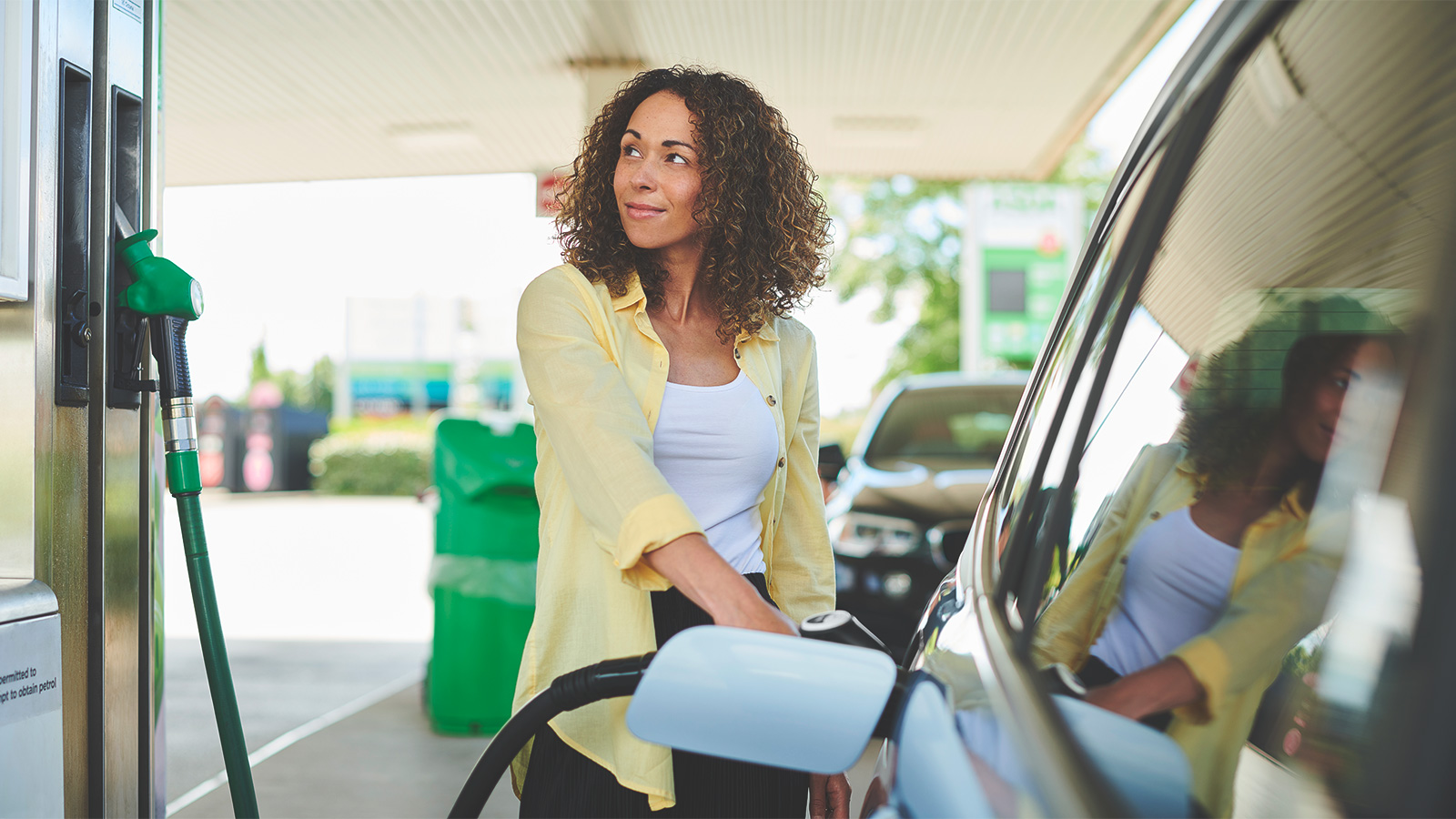 A woman fills up her vehicle with biofuels